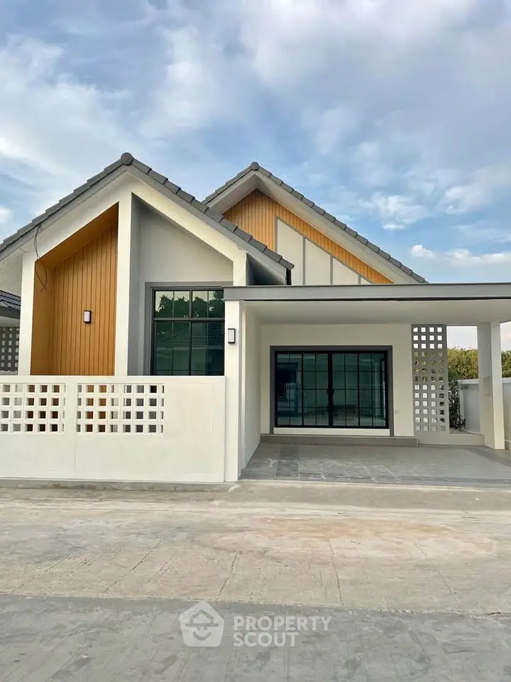 Modern single-story house with sleek design and spacious driveway