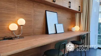 Stylish study area with wooden desk, modern chairs, and ambient lighting, perfect for productivity and relaxation.