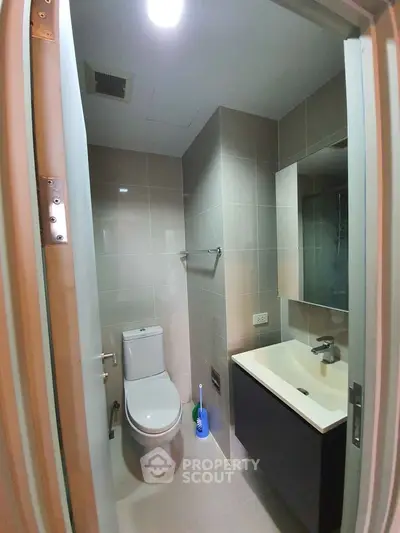 Modern bathroom with sleek fixtures and neutral tiles