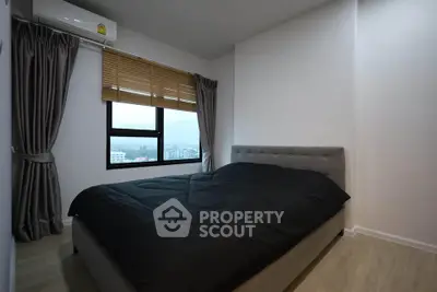 Modern bedroom with large window and stylish decor in urban apartment
