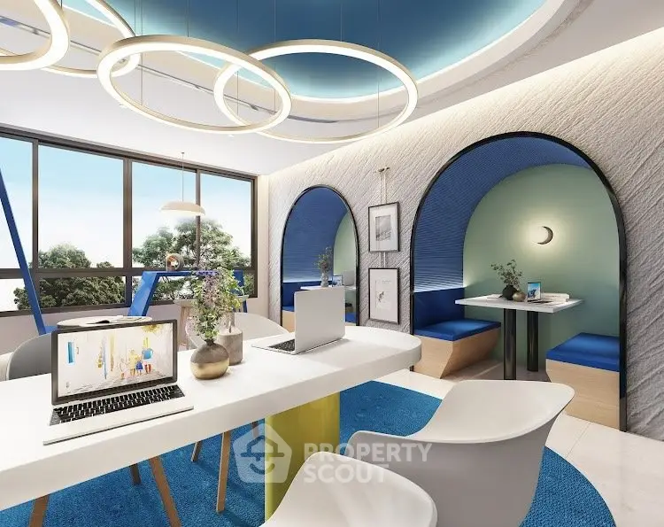 Modern study room with sleek design, featuring laptops, stylish chairs, and large windows with a scenic view.