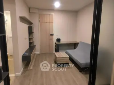 Modern living room with sleek furniture and wooden flooring in a cozy apartment.