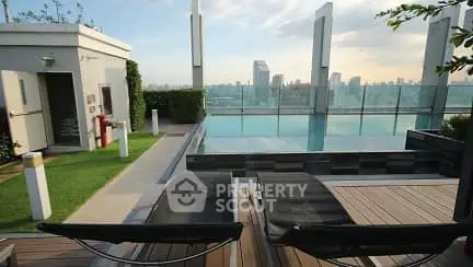 Luxurious rooftop pool with stunning city skyline view and modern lounge chairs.