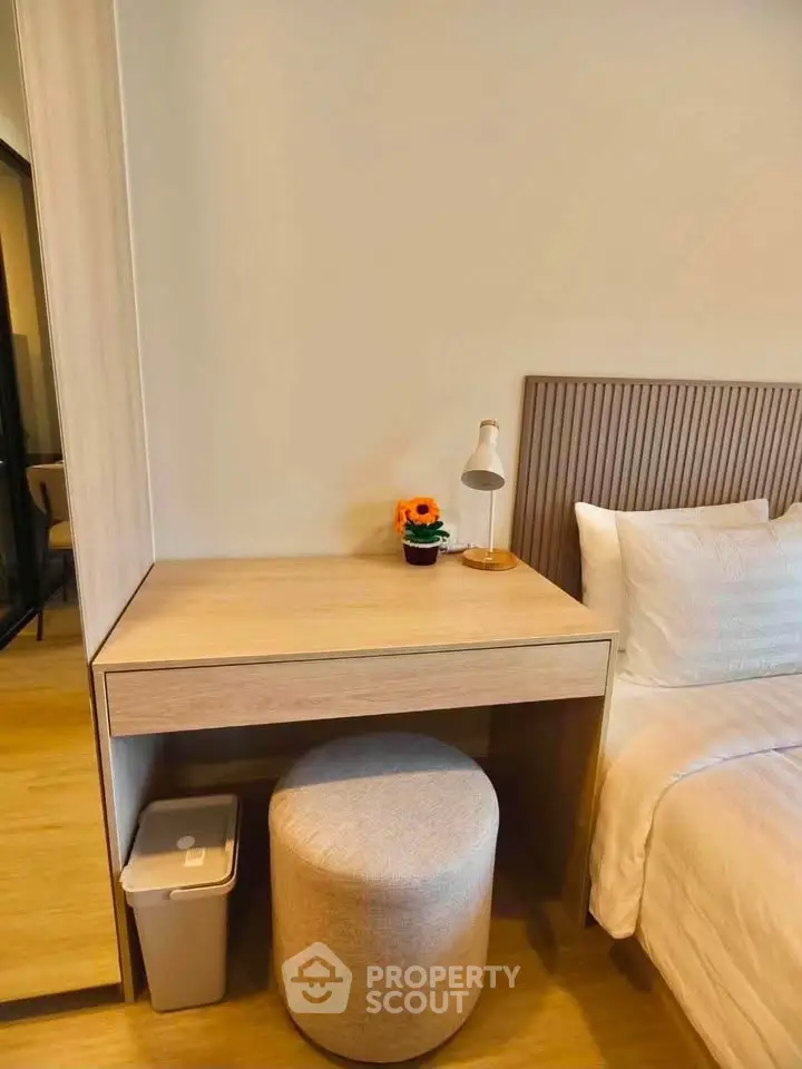 Cozy bedroom with modern decor, featuring a stylish vanity and comfortable bed, perfect for relaxation.