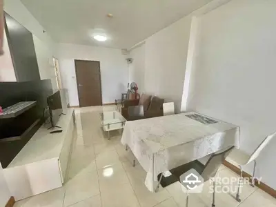 Spacious living room with modern furniture and dining area in a bright apartment.