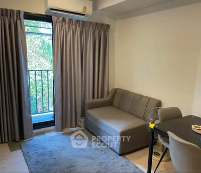 Cozy living room with sofa, table, and balcony view in modern apartment