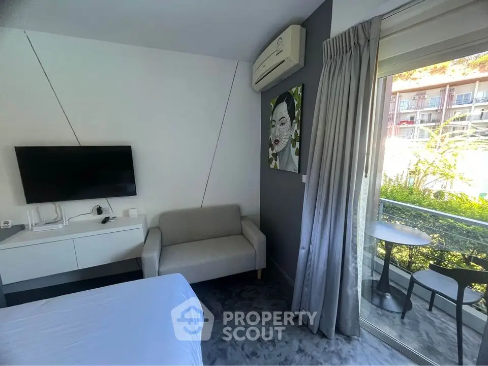 Modern bedroom with balcony view, featuring sleek decor and natural light.