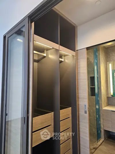 Modern bathroom with sleek wooden storage and elegant lighting