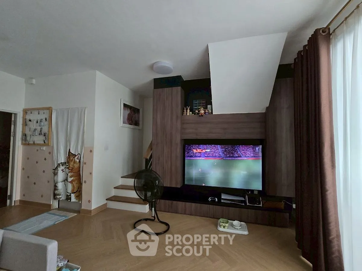 Modern living room with stylish wooden TV unit and cozy decor