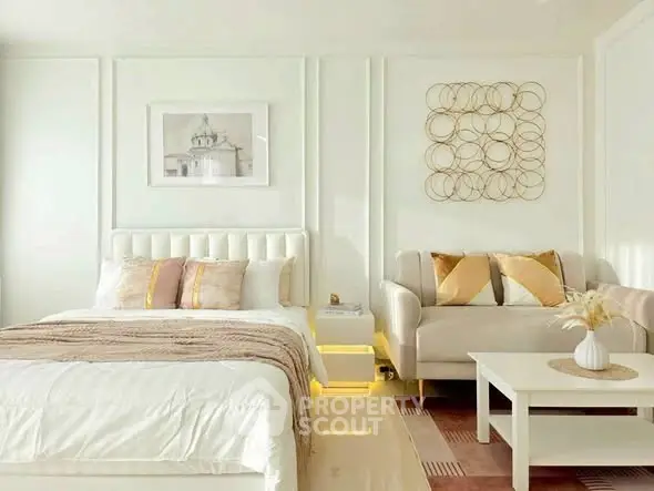 Luxurious bedroom with elegant decor and cozy seating area, perfect for relaxation.