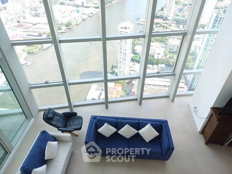 Stunning high-rise living room with panoramic river view and modern furniture.