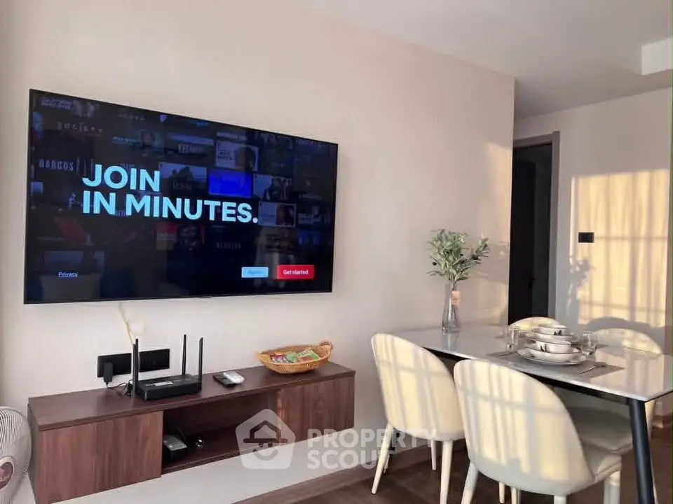 Modern living room with wall-mounted TV and stylish dining area