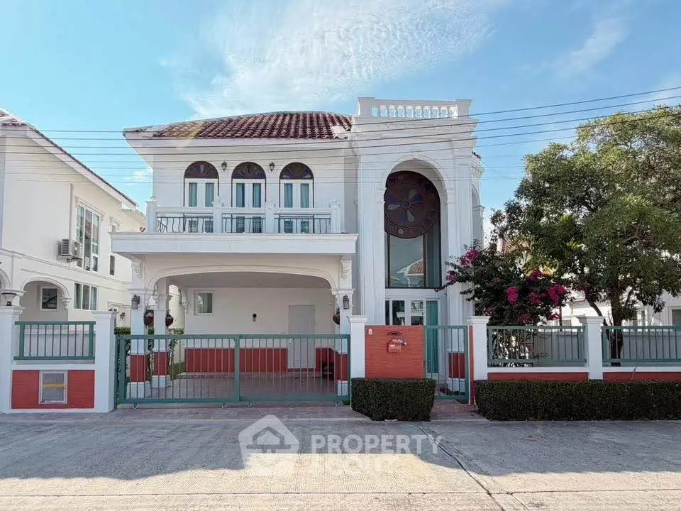 Elegant two-story house with classic architecture and spacious driveway in a serene neighborhood.
