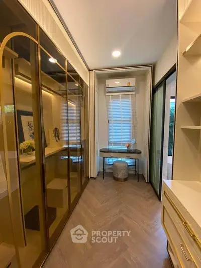 Luxurious walk-in closet with elegant cabinetry and stylish decor