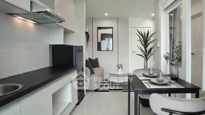 Modern open-plan kitchen and living area with sleek design and stylish decor.