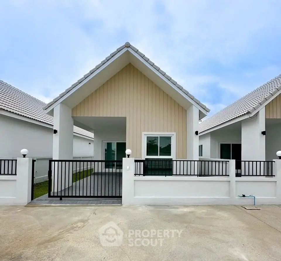 Charming modern single-story house with a gated front yard and sleek design.