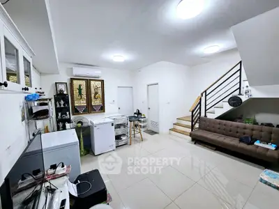 Spacious living room with modern decor and staircase in a stylish home