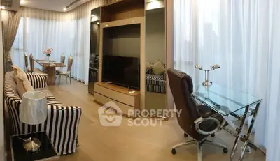 Modern living room with stylish furniture and glass desk in a spacious apartment.