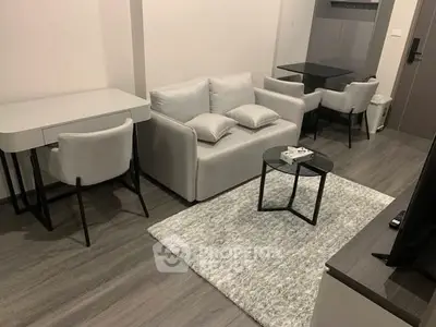 Modern living room with sleek furniture and stylish decor in a cozy apartment setting.