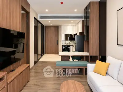 Modern living room with sleek wooden furniture and open layout in contemporary apartment.