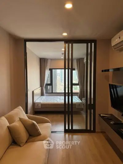 Modern studio apartment with sliding glass doors and city view