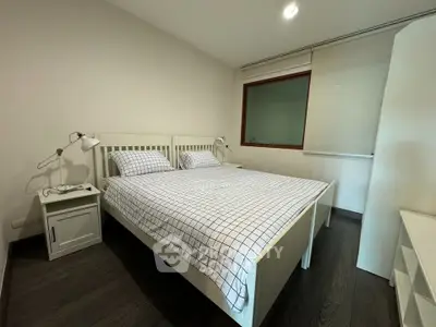 Cozy bedroom with modern decor and ample natural light