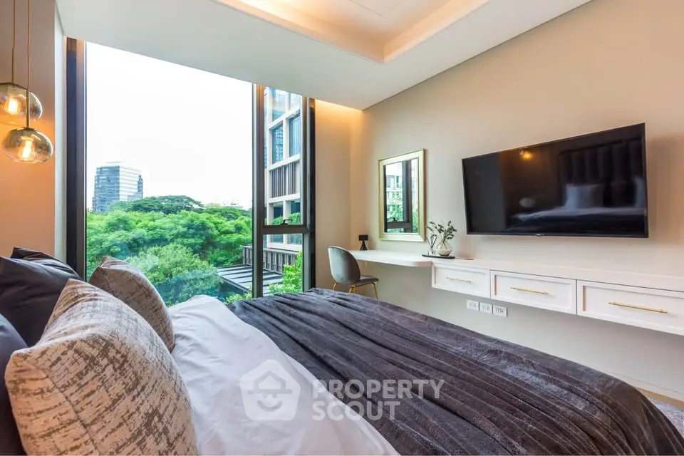 Luxurious bedroom with modern decor and stunning city view, featuring a wall-mounted TV and elegant lighting.