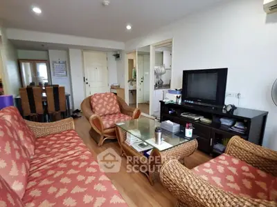Spacious living room with wicker furniture and modern decor in a cozy apartment.