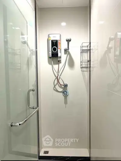 Modern bathroom shower with glass door and electric water heater