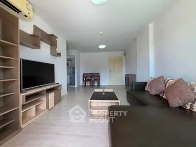 Spacious living room with modern furniture and entertainment center