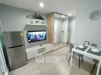 Modern living room with sleek decor and dining area in open layout apartment.
