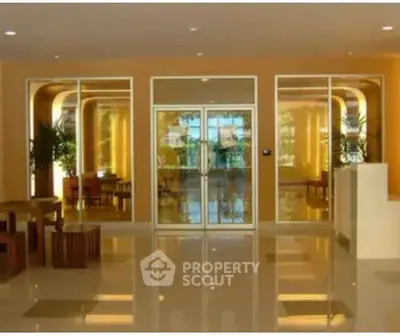 Elegant building entrance with glass doors and modern decor