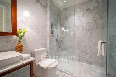 Luxurious marble bathroom with modern fixtures and elegant lighting
