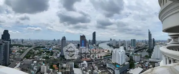 Stunning cityscape view from a high-rise balcony overlooking a vibrant urban skyline.