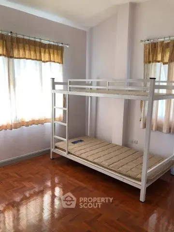 Spacious bedroom with bunk bed and natural light from large windows