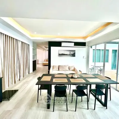 Spacious modern living room with elegant dining area and natural light