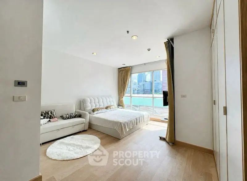 Spacious bedroom with city view and modern decor