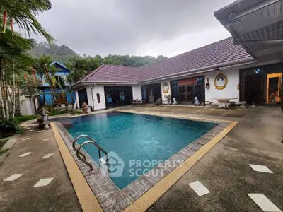 Luxurious villa with a stunning pool and spacious outdoor area, perfect for relaxation and entertainment.