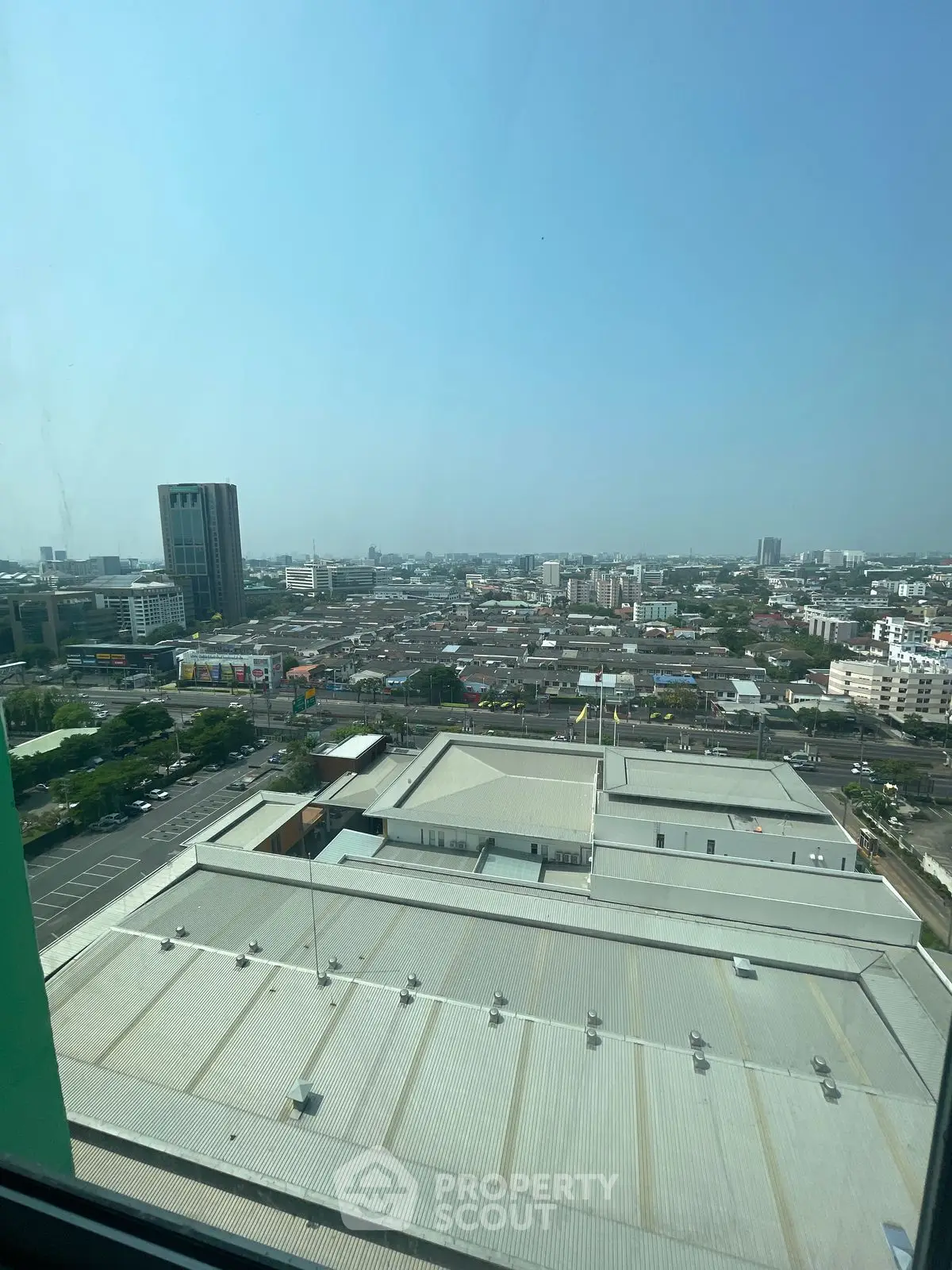 Stunning urban cityscape view from high-rise building window showcasing expansive skyline.