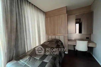 Cozy bedroom with modern design, featuring a single bed and stylish desk, perfect for a compact living space.