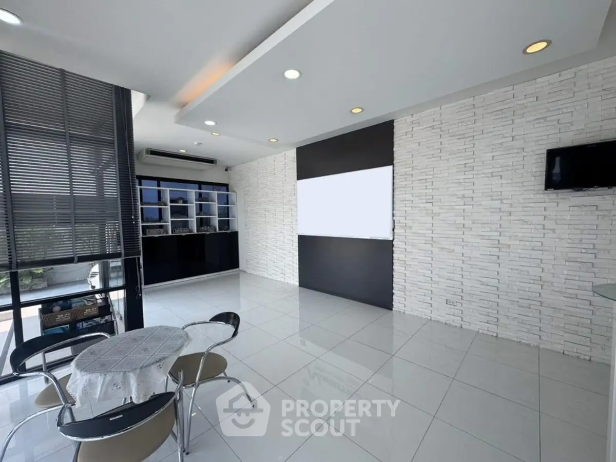 Modern living room with sleek design, large windows, and stylish furniture in a contemporary apartment.