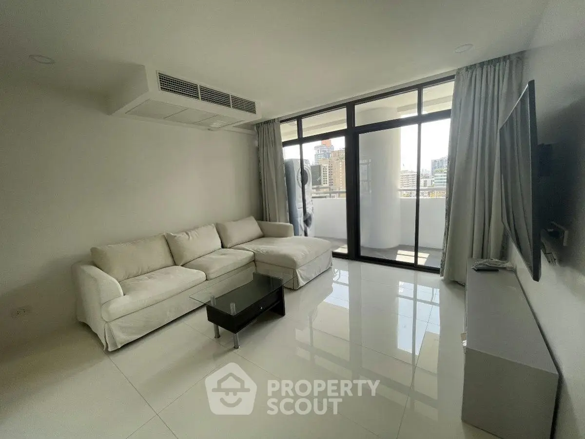 Modern living room with white sofa and city view balcony