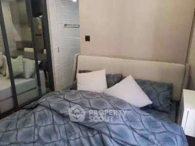 Cozy bedroom with modern decor and plush bedding in a stylish apartment.