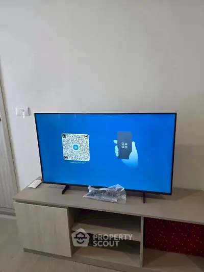 Modern living room with sleek TV setup on stylish wooden console, perfect for entertainment.