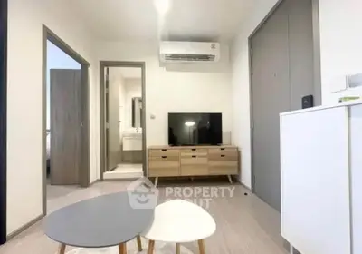 Modern living room with sleek furniture and wall-mounted air conditioning unit