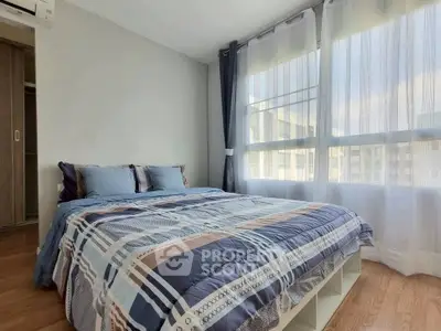 Bright and cozy bedroom with large window and modern decor