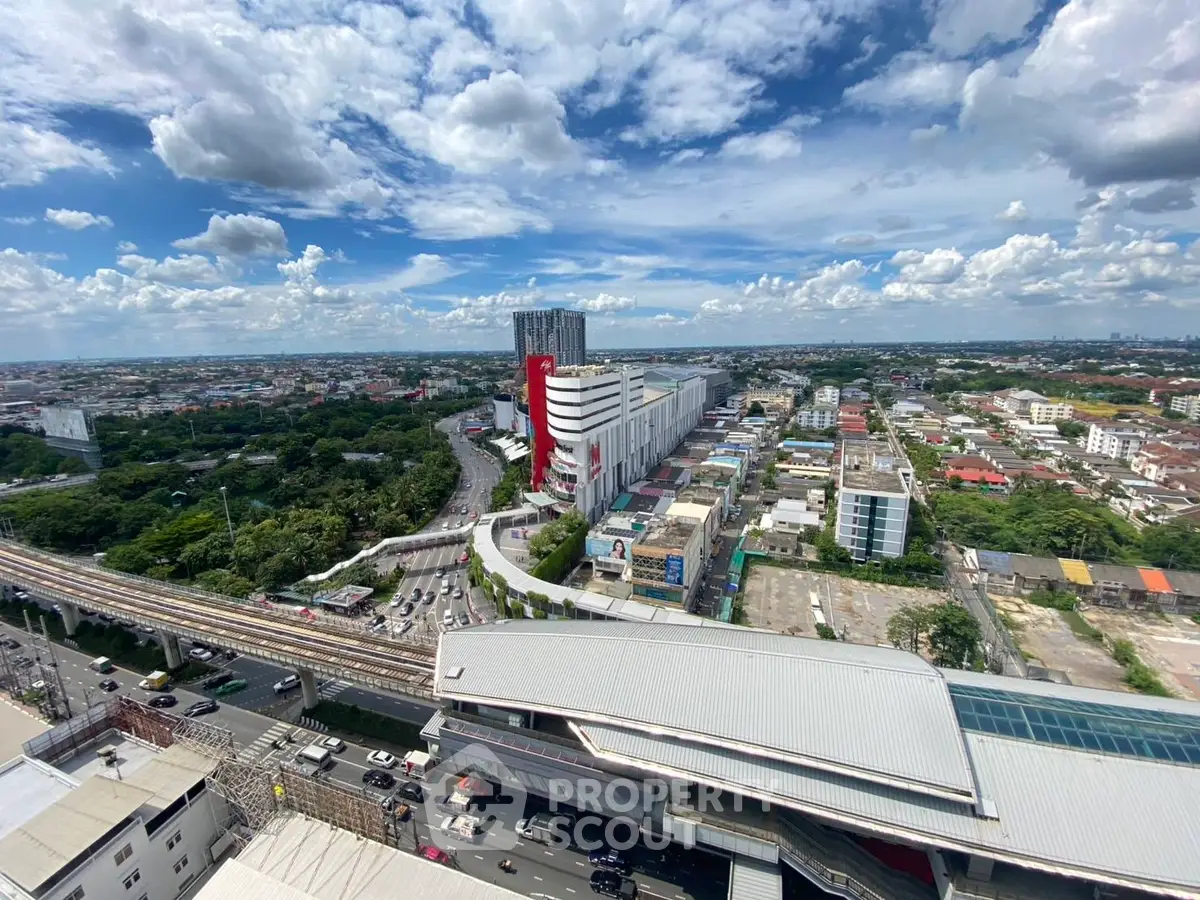 Stunning aerial view of urban landscape with modern architecture and lush greenery, ideal for real estate investment.