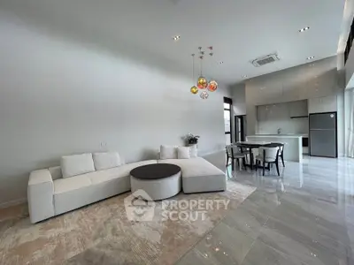 Spacious modern living room with elegant furniture and open kitchen layout