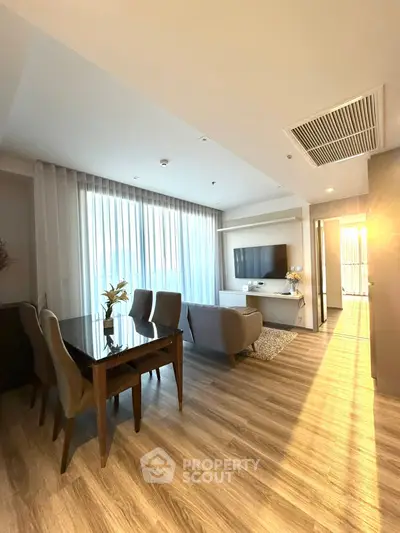 Spacious modern living room with elegant dining area and abundant natural light