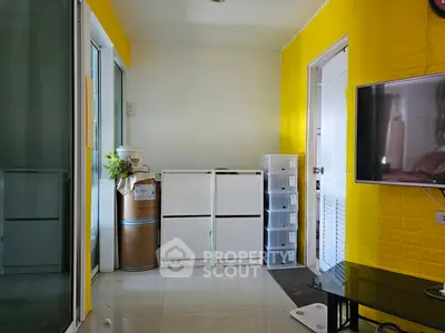 Bright living room with yellow accent wall and modern furnishings